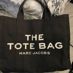Marc Jacob’s. All black tote and white lettering. It is 13 inches.